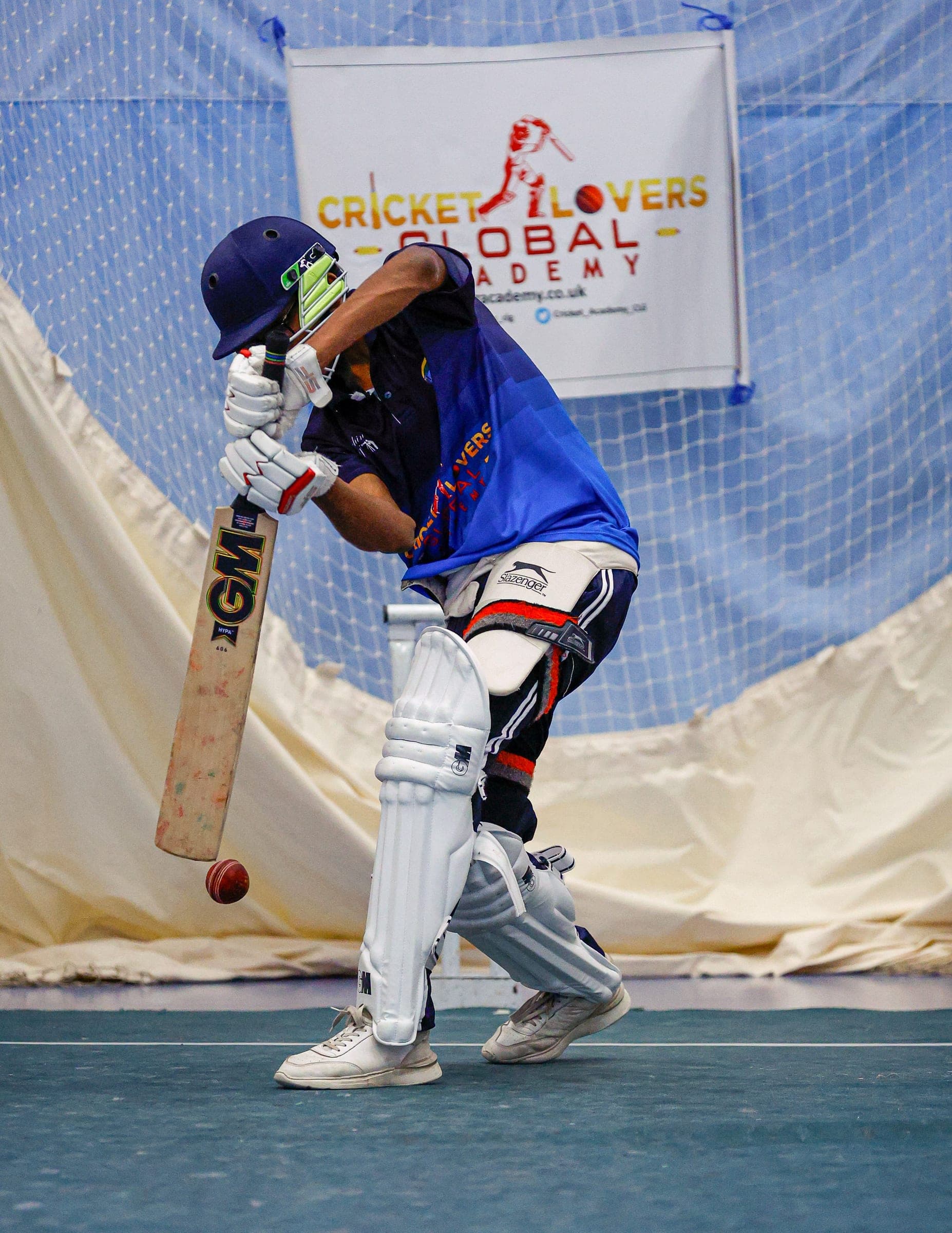 Young batter in academy kit