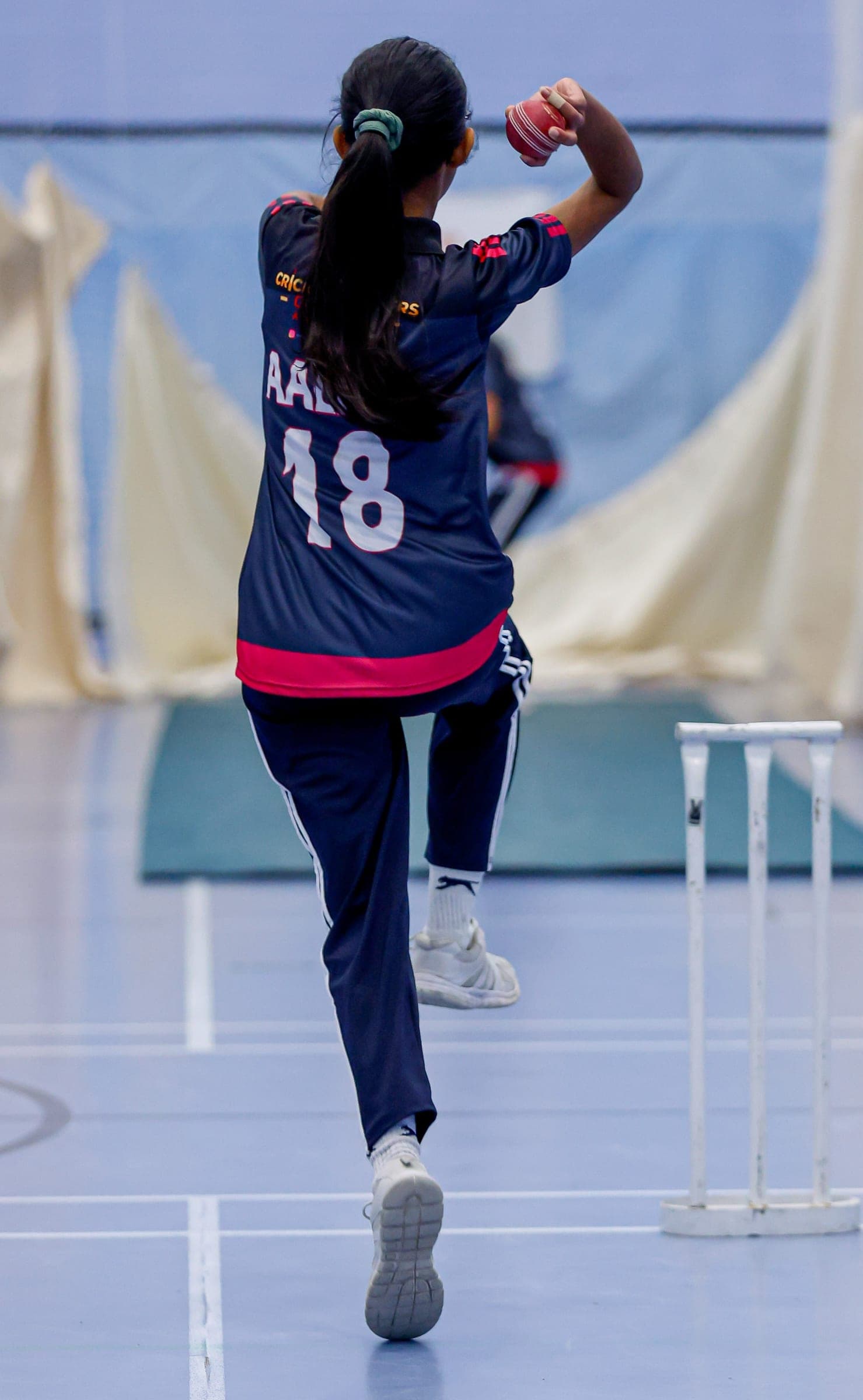 Girl bowling a cricket ball