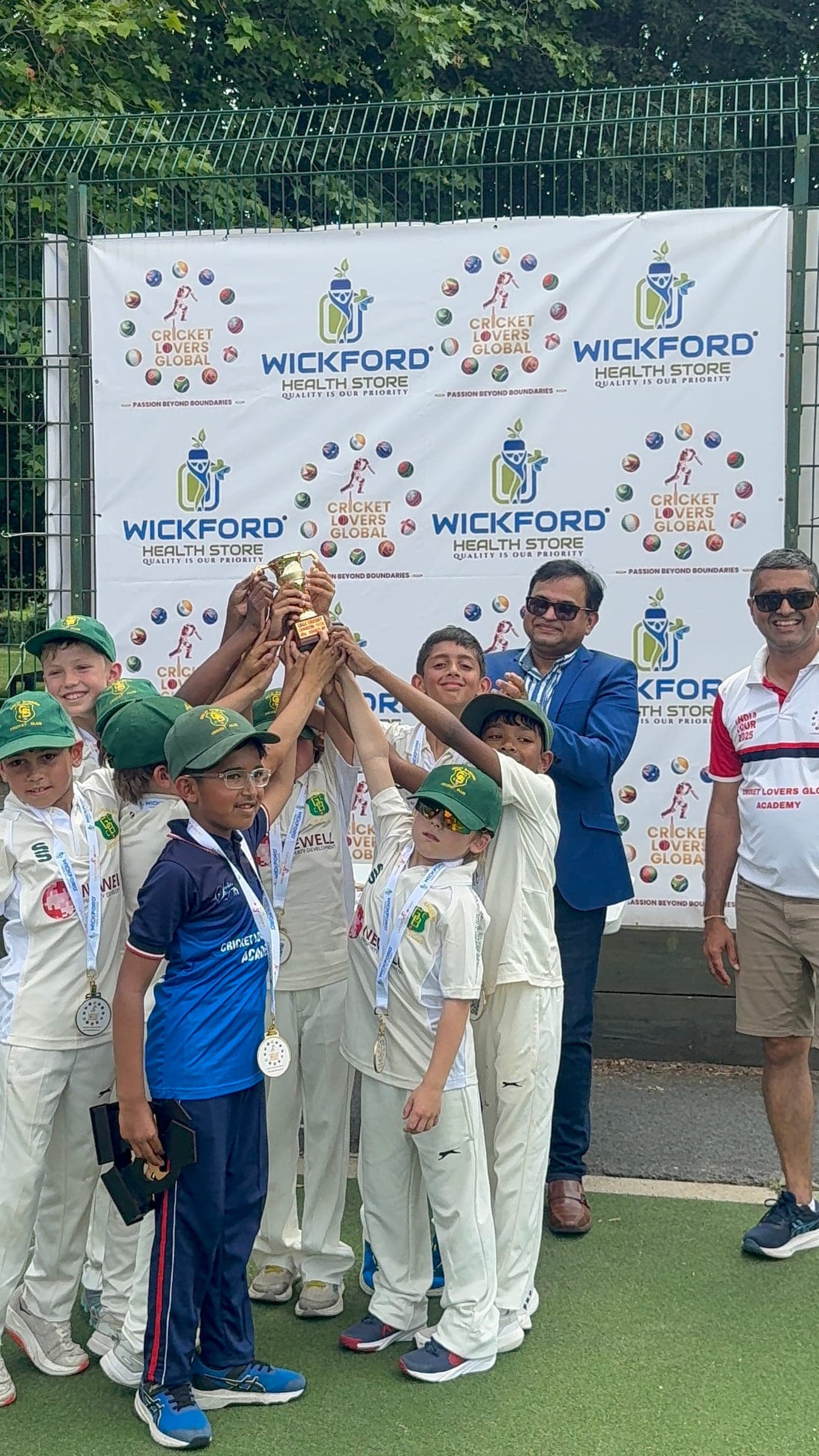 Junior players lifting the trophy at Cricket Carnival 2026
