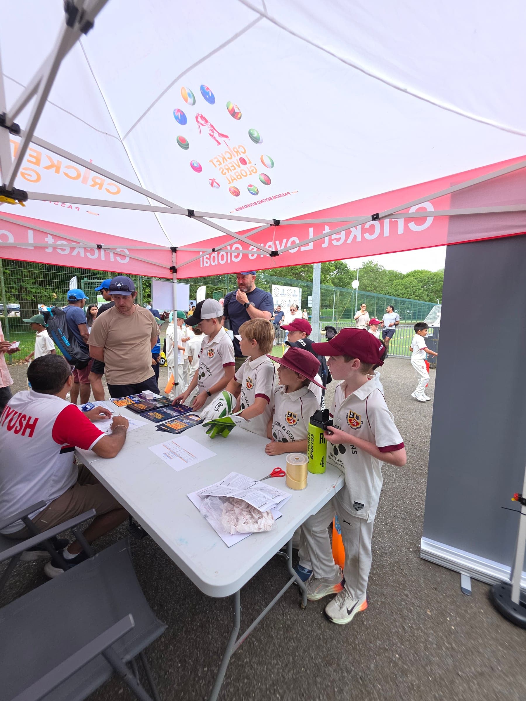 Young players checking in under the Cricket Lovers Global tent at Carnival 2026