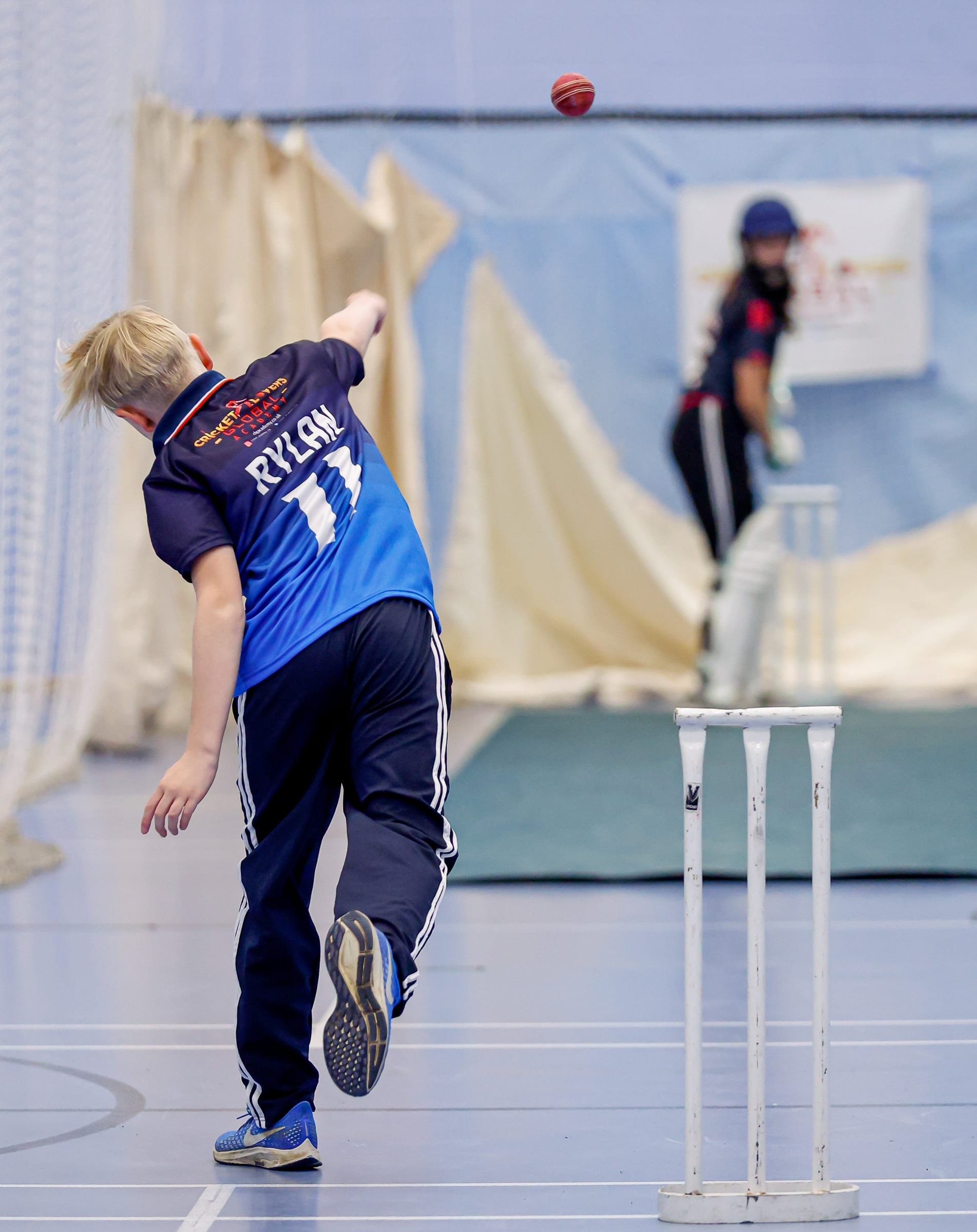 Boy bowling to a girl batter at CLG Academy